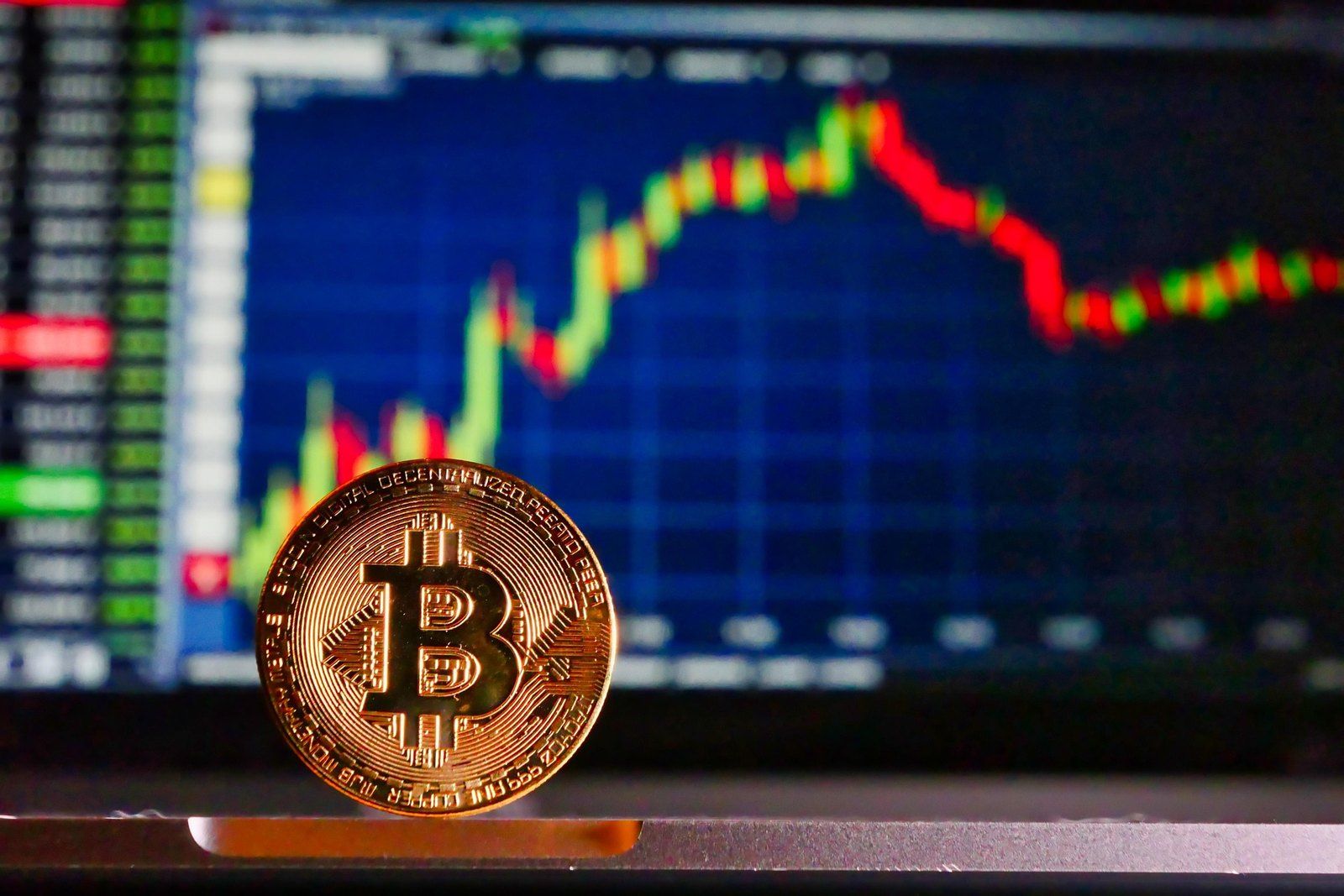 Bitcoin coin in front of a price chart